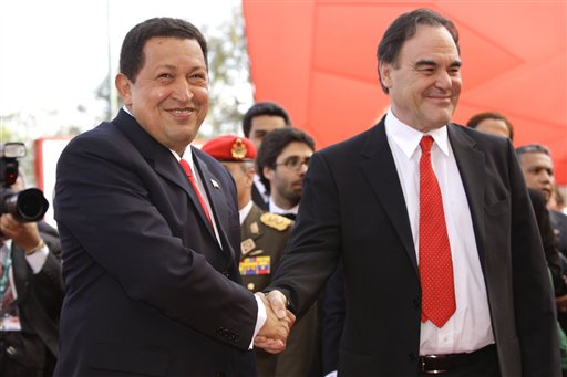 Venezuelan President Hugo Chavez (left) shakes hands with director Oliver Stone (VTV)